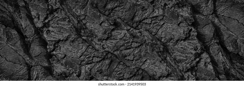 Black white rock texture  Dark gray stone wall background and space for design  Cracked rough mountain surface  Close  up  Wide banner  Panoramic  Granite backdrop  Grunge 