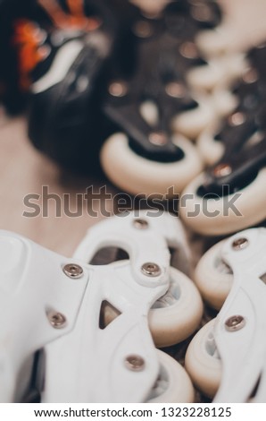 Black and white roller skates for a couple. Wheels close up view. Ready to skate on the roller rink concept.