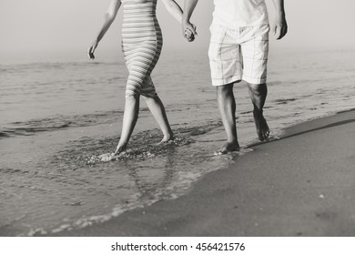 Black And White Romantic Couple Man And Woman Walking On Beach Holding Hands Together, Sunny Day Outdoors Background