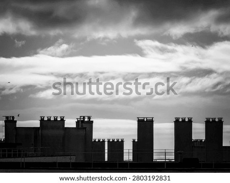 Black and White Rooftops and Chimneys Under Dramatic Clouds in Lisbon, Portugal
