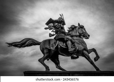 Black and white of a samurai on horseback.