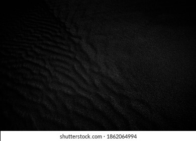 Black and White Sand beach macro photography. Texture of black and whote sand for background. Black and white poster texture sand in the desert.