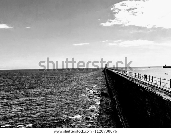 black and\
white sea view and walkway ti\
lightbouse