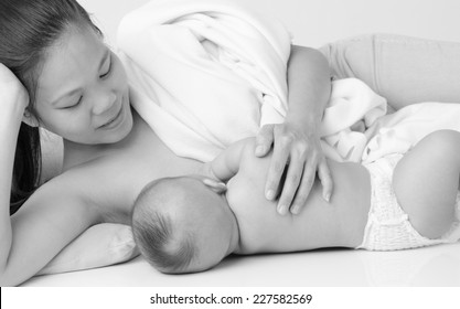 Black And White Shot Of Asian Woman Breastfeeding Her Baby