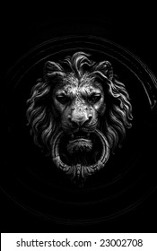 Black and white shot of  a classic door knocker in the shape of a lion