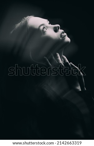 Similar – Young woman in black lingerie in chiaroscuro lighting