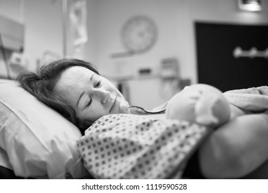 Black And White Shot Of Mother Holding Her Newborn Baby Right After Delivery