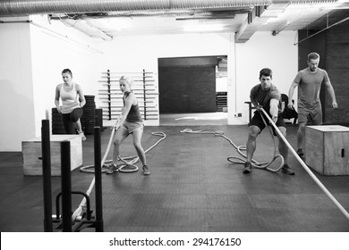 Black And White Shot Of People In Gym Circuit Training