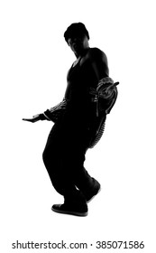 Black And White Silhouette Of A Male Dancer Posing With Dance Moves.  He Is Backlit And In Shadow To Show Off His Body Poses. 