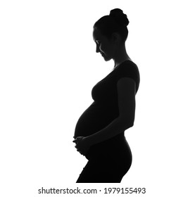 black and white silhouette portrait of pregnant woman with hand on belly, long-awaited pregnancy, ivf pregnancy