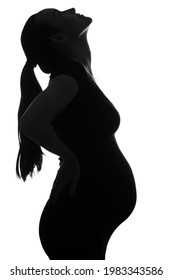 Black And White Silhouette Portrait Of Pregnant Woman, Head Tilted Up On White Background, Vertical