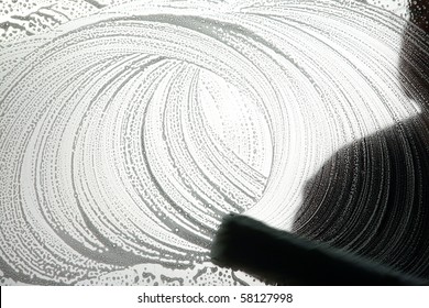 Black And White Silhouette Of A Window Washer Washing A Window