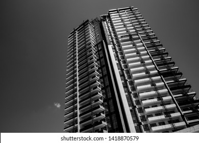 Black and white skyscraper from down. Perspective of a high building construction.