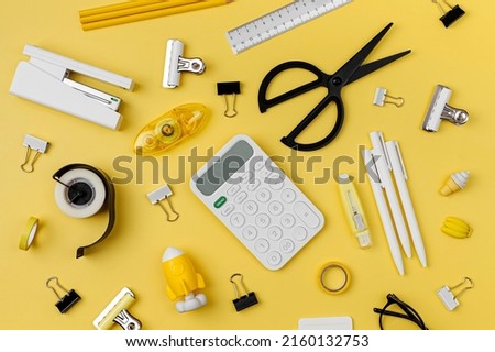 Black and white stationery on yellow background. School stationery supplies. Workplace organization. Concept back to school.	