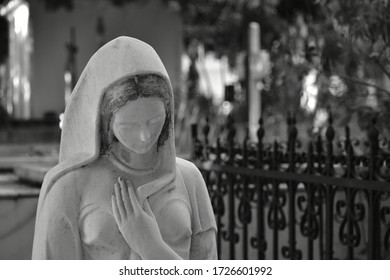 Black And White Statue Of The Virgin Mary In Stone In The Old Cemetery