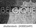 black and white stone inscription word Belgique Belgium Belgian statue carved stone carving monument cut in stone concrete structure war memorial historical object military history sign remembering