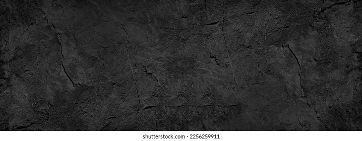 Black white stone texture. Rock surface. Close-up. Like a old rough concrete wall. Dark gray grunge background with space for design. Template. Backdrop. Wide banner. Panoramic.