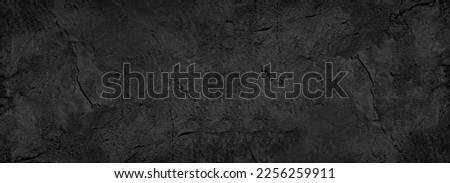 Black white stone texture. Rock surface. Close-up. Like a old rough concrete wall. Dark gray grunge background with space for design. Template. Backdrop. Wide banner. Panoramic.