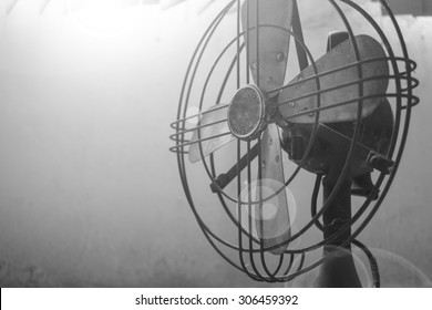Black and white  style: In the hottest early morning, the oldie fan broke down. Extremely shallow focus.