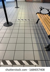 Black And White Tape Marking 6 Feet Apart On Floor Promoting Social Distancing In Public Building