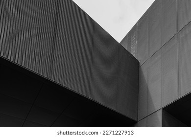 Black and white tone, Exterior architectural detail of aluminium perforated cladding facade of modern buildings. Abstract Urban metropolis background.