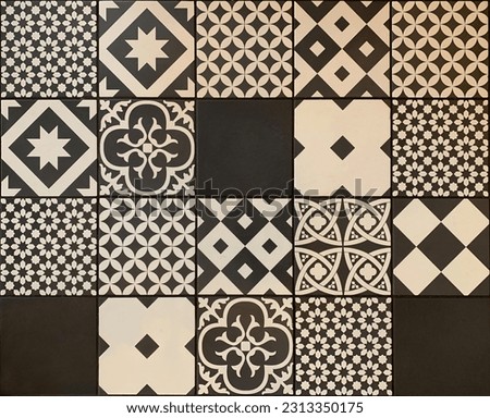 Black white traditional ceramic floor or wall tile as a texture for background. Vintage geometric and floral details on Portuguese, Lisbon, Azulejos pattern on ceramic or cement patchwork tiles.