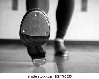 Black and white version of Heel toe in tap shoes in dance class