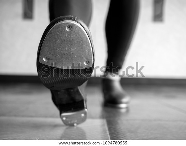 Black and white version of Heel toe in tap shoes in
dance class
