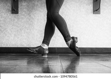 Black and white version of Toe Heel stand in tap shoes during dance class