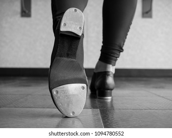 Black and white version of Toe Tap in Tap shoes with a back view