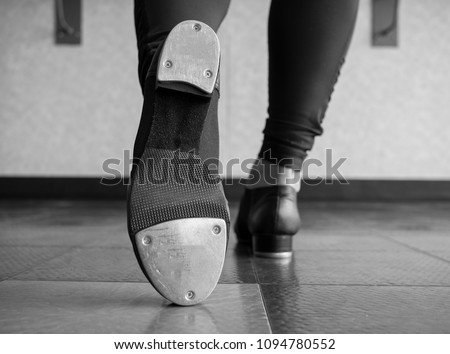 Black and white version of Toe Tap in Tap shoes with a back view