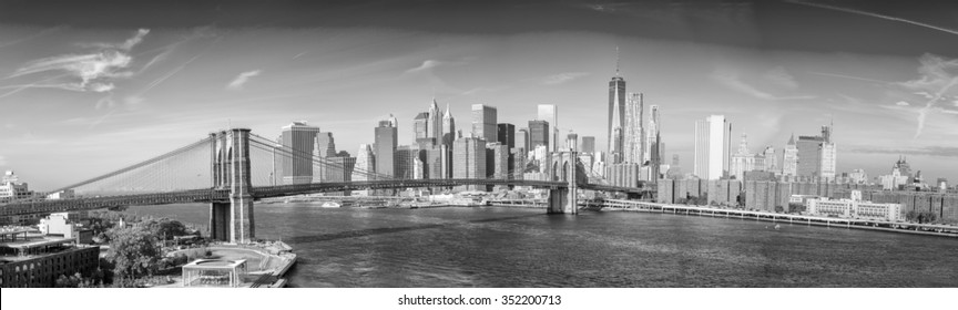 Black and white view of Brooklyn Bridge with panoramic of Downtown Manhattan.