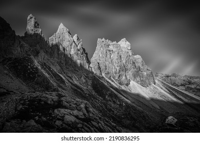 Black and white view of small lake with mountains reflections at the foots of rocky ridges of Pala di Popera peak in Comelico region, Dolomites, Italy - Powered by Shutterstock