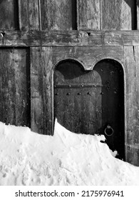 Black And White Viking Door In Iceland With Snow Drift In Spring