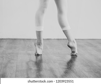 Black And White Wallpaper Faceless Ballet Dancer Warming Up In Studio Copy Space Room For Text. No Face Dancing Female Feet Legs Stretching Indoors Toes Professional Arts. Modern Contemporary Art 