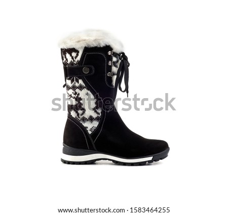 black white warm winter women’s boots with a pattern of deers on a white background, isolate, side view