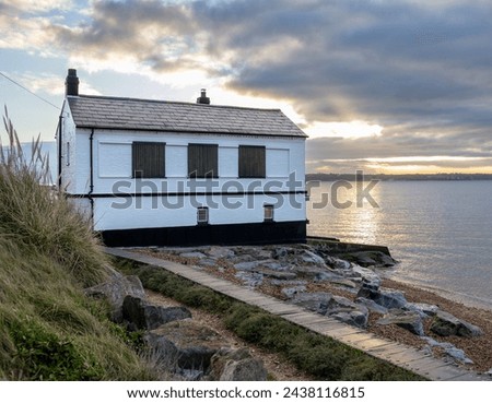The black and white Watch House at sunrise at Lepe on the edge of The Solent