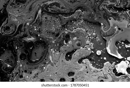 Black and white watercolor ink in oil water. Cool trending screensaver. Abstract trending background.