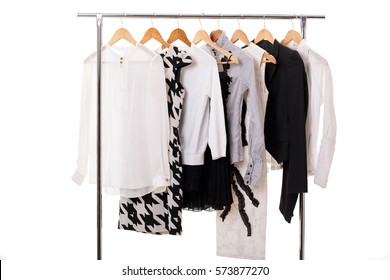 Black And White Womens Clothes On Hangers On Rack On White Backg