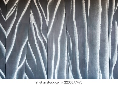 Black and white zebra striped painted on an exterior wall or fence made of wooden planks. Artistic housing backdrop - Powered by Shutterstock