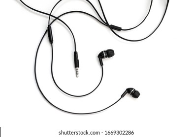Black wired vacuum earplugs isolated on a white background. Headphones headset. In-ear headphones for listening music and sounds on portable devices for music lovers. - Shutterstock ID 1669302286