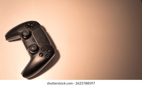 A black wireless controller for the PlayStation 5 console sits on a smooth, light background.