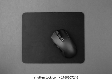 Black wireless mouse on a mouse pad, top view. - Powered by Shutterstock