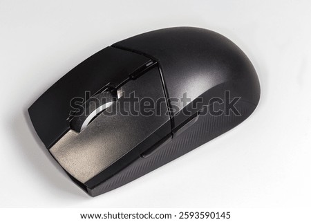 Black wireless optical computer mouse with scroll wheel and additional side buttons on a gray background 