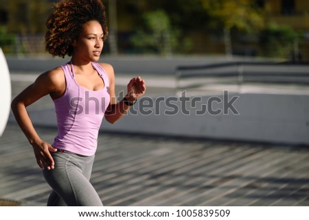 Similar – Black woman afro hairstyle running outdoors in urban road