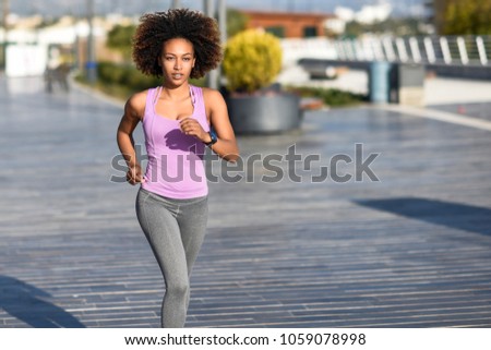 Similar – Black woman afro hairstyle running outdoors in urban road