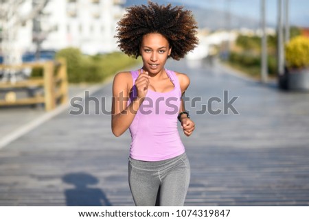 Similar – Black woman afro hairstyle running outdoors in urban road