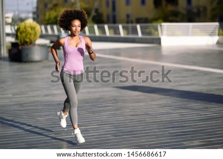 Similar – Black woman afro hairstyle running outdoors in urban road