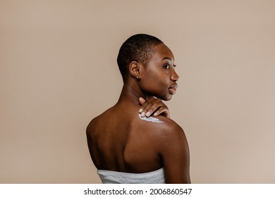 Black Woman Applying Body Cream