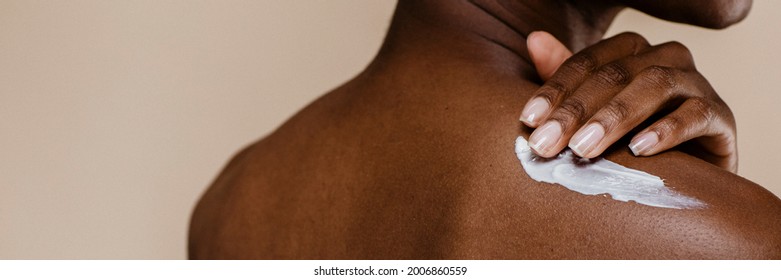 Black Woman Applying Body Cream